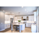 classic light vein cut travertine tile 12x24 polished installed to kitchen floor wide view white cabinets
