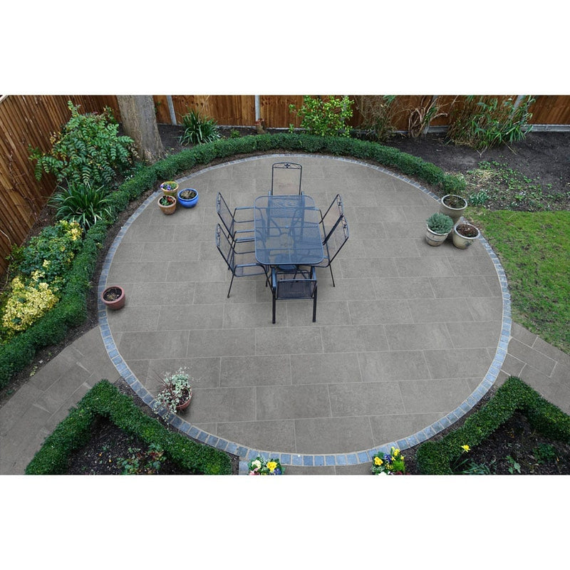 concerto grigio porcelain pavers 18x36in matte floor tile LPAVNCONGRI1836 installed on a nice round patio with iron wrought table and 6 chairs