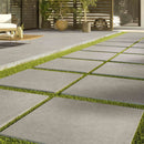 concerto grigio porcelain pavers 24x24in matte floor tile LPAVNCONGRI2424 installed to a porch and walkway of a modern house closeup