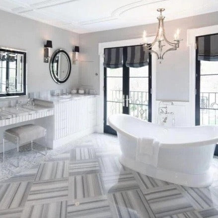 equator white marble floor wall tile 24x24 polished installed on modern contemporary bathroom with modern furniture and white bathtub in middle