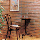manufactured stone brick veneer slimfix orange handmade B05NG 102267 installed on wall wooden chair table painting