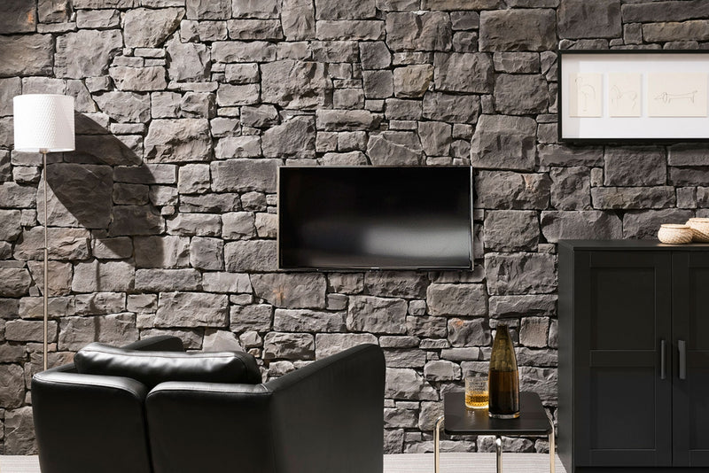 manufactured stone veneer ashlar pattern masso anthracite handmade S01TH 101196 installed inside wall TV leather black armchair side table