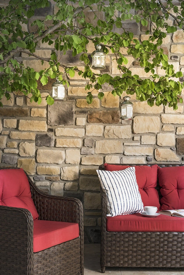 manufactured stone veneer ashlar pattern masso mixed coffee sand anthracite rattan installed outside wall plants