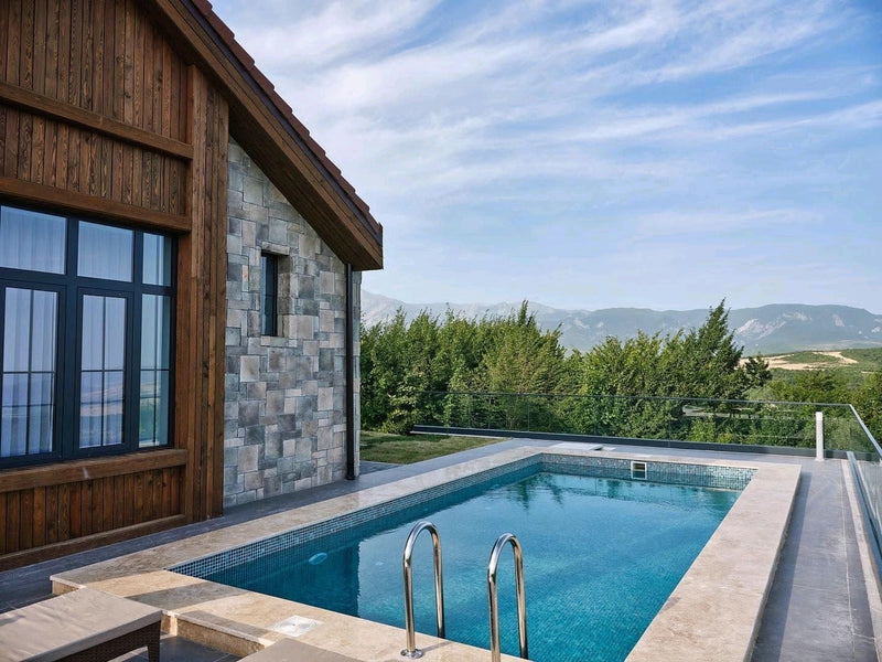 manufactured stone veneer ashlar pattern petra olive handmade S11OL 101241 installed facade house swimming pool nice view