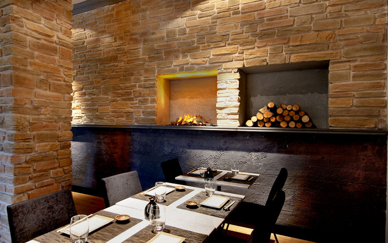manufactured stone veneer slate look grand canyon pearl ash sand mixed installed on restaurant wall woods fireplace