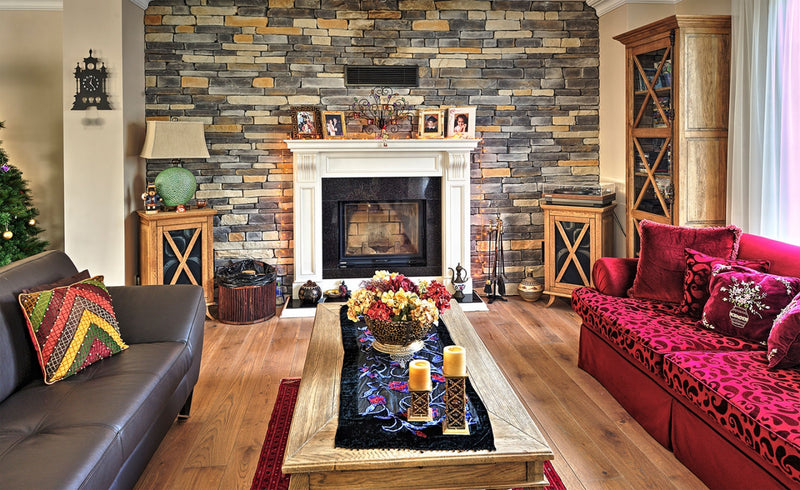 manufactured stone veneer slate look Sierra sand mixed handmade installed wall inside house seats fireplace wooden coffee table